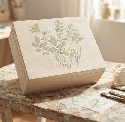 Botanical decoupage stencil set with floral and leaf designs displayed beside a decorated canvas tote bag
