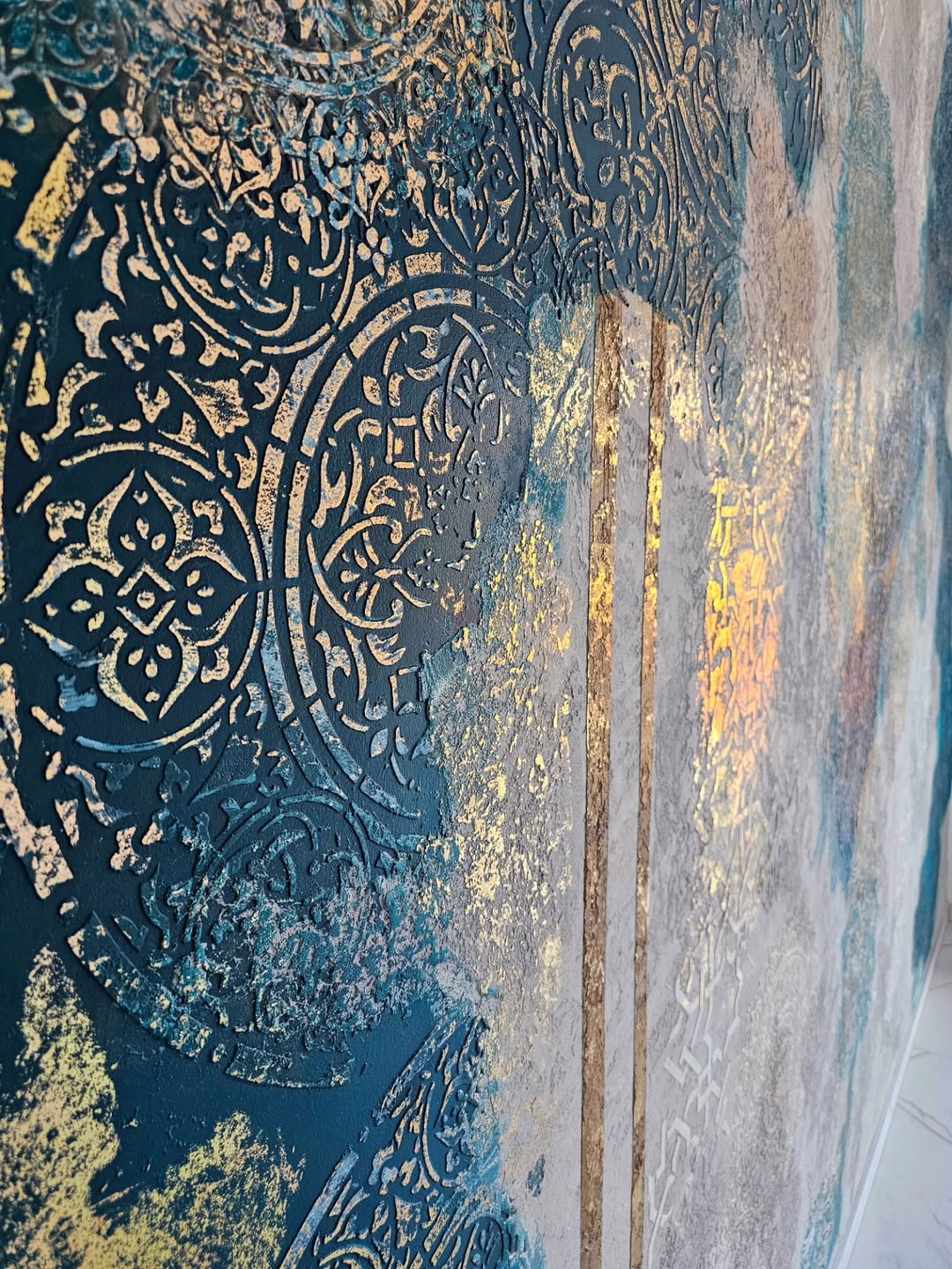Reusable mandala wall stencil creating plaster pattern on textured wall